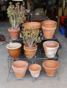 A painted wrought iron three tier pot stand together with a collection of 13 assorted terracotta and