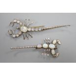 Two white metal scorpion brooches, one set with moonstones, the other with opals, largest 9cm.