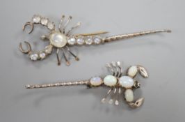 Two white metal scorpion brooches, one set with moonstones, the other with opals, largest 9cm.