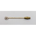 An Edwardian yellow metal and diamond cluster set stick pin, 58mm, gross 1.4 grams.