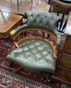 A Victorian style green leather, stained beech swivel desk chair, width 63cm, depth 57cm, height