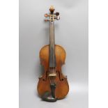 A 19th century violin with 14 inch 2 piece back, unlabelled, cased with silver mounted bow.