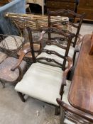 A set of six Chippendale style mahogany dining chairs with pierced ladder backs, two with arms