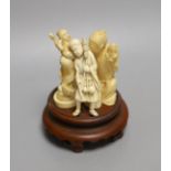 Three Japanese ivory okimono, of a doll maker, a street seller and Kinko seated on a carp, Meiji