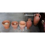 Two Greek style terracotta garden urns, one with iron stand, together with twelve assorted