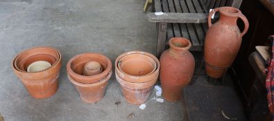Two Greek style terracotta garden urns, one with iron stand, together with twelve assorted