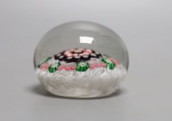 A mid 19th century French concentric millefiori glass paperweight, with scrambled latticino ground