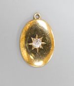 A yellow metal and single stone diamond set oval pendant, 19mm, gross 3 grams.