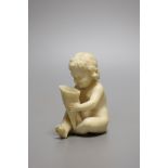 A 19th century Continental carved ivory figure of a child holding a cornucopia - 7cm tall