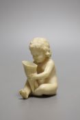 A 19th century Continental carved ivory figure of a child holding a cornucopia - 7cm tall