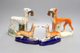Two Staffordshire greyhounds and a pair of recumbent Staffordshire ‘greyhound’ desk stands.