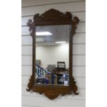 A George III style mahogany fret cut wall mirror with gilt slip, width 50cm, height 85cm.