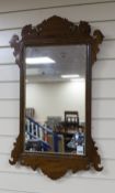 A George III style mahogany fret cut wall mirror with gilt slip, width 50cm, height 85cm.