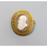 A late Victorian yellow metal and oval cameo shell set brooch, carved the bust of a gentleman to