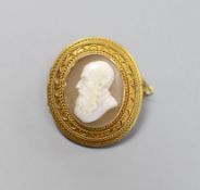 A late Victorian yellow metal and oval cameo shell set brooch, carved the bust of a gentleman to