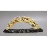 A Japanese boars tusk carving of two confronting dragons, Meiji period - 12cm high