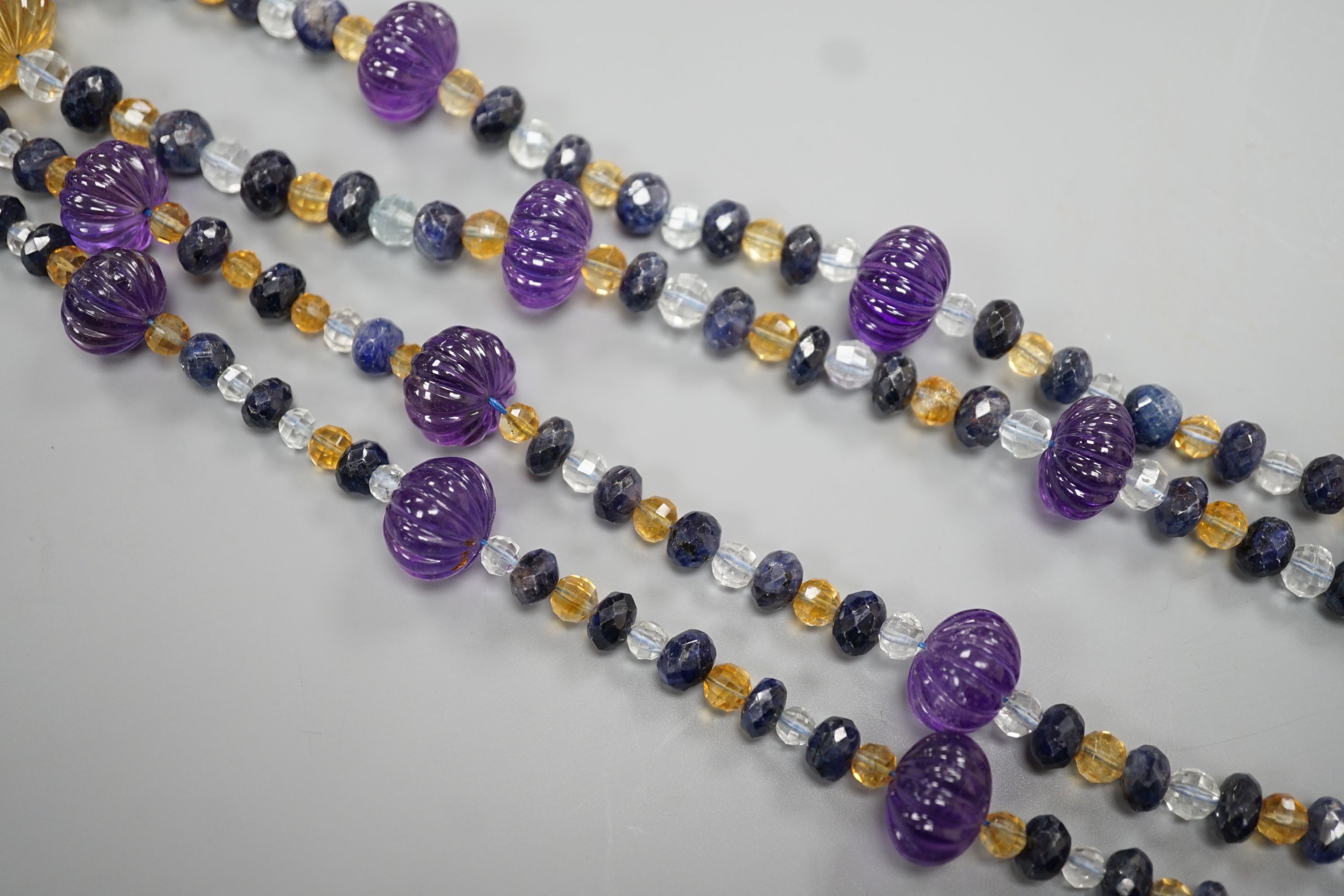 A modern single strand fluted amethyst and facet cut sapphire, citrine and aquamarine bead set - Image 3 of 4