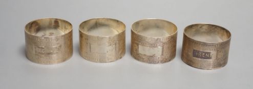 A set of four George VI engine turned silver napkin rings, H. Bros, Birmingham, 1943/4, two engraved