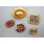 Two 19th century gilt metal and plaited hair set mourning brooches, two other mourning brooches