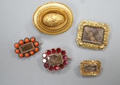 Two 19th century gilt metal and plaited hair set mourning brooches, two other mourning brooches