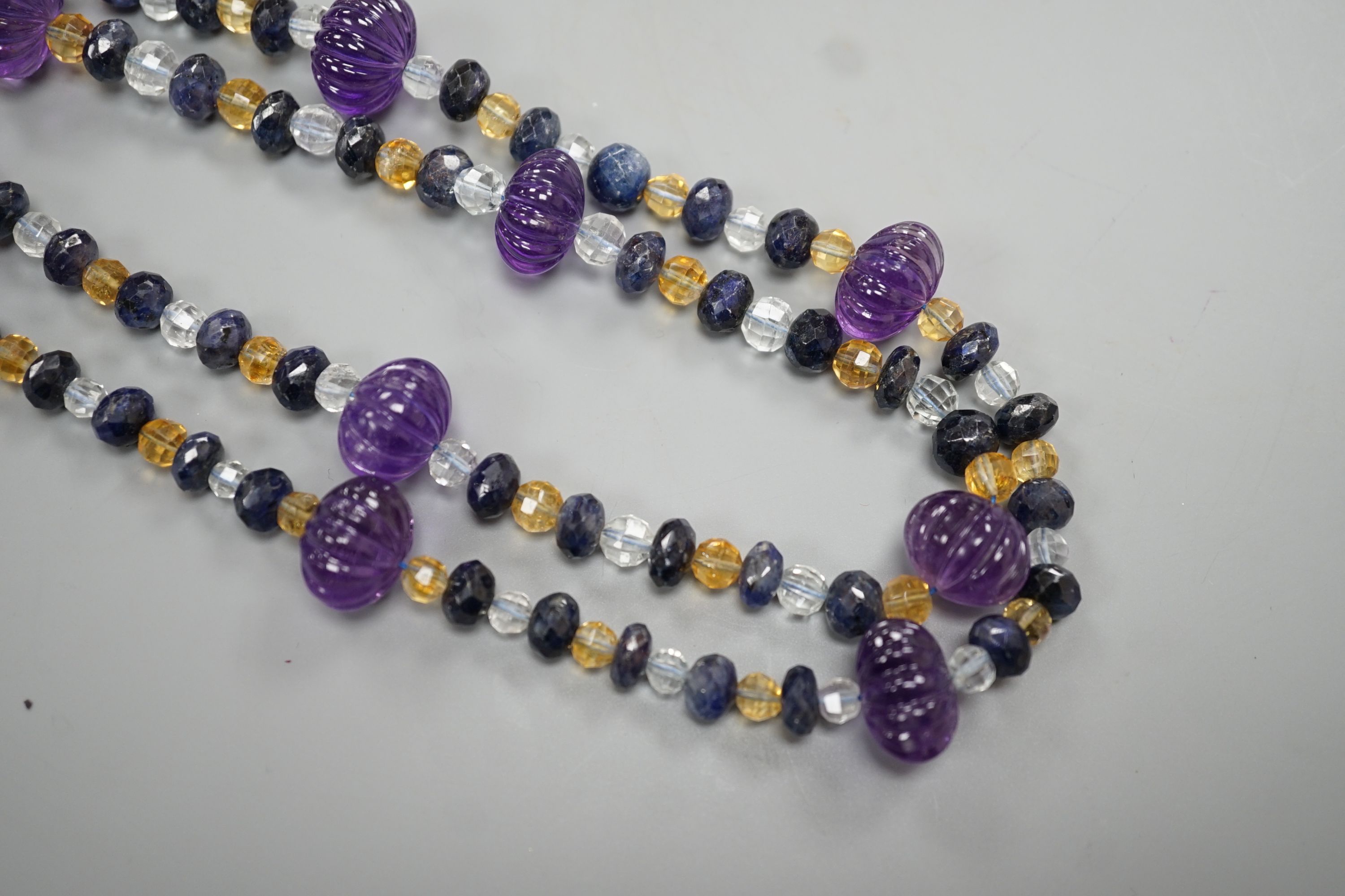 A modern single strand fluted amethyst and facet cut sapphire, citrine and aquamarine bead set - Image 2 of 4