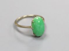 A white metal and oval cabochon jade set ring, size L, gross 2.4 grams.