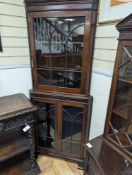 An Edwardian mahogany glazed standing corner cabinet, fitted four shelves, width 80cm, depth 42cm,