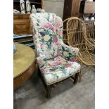 A George III provincial upholstered wing armchair, width 71cm, depth 70cm, height 110cm
