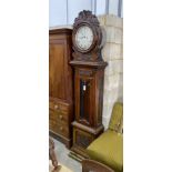 A Victorian carved oak eight day longcase clock by J.R.Thomas dated 1898, having silvered circular