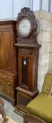 A Victorian carved oak eight day longcase clock by J.R.Thomas dated 1898, having silvered circular