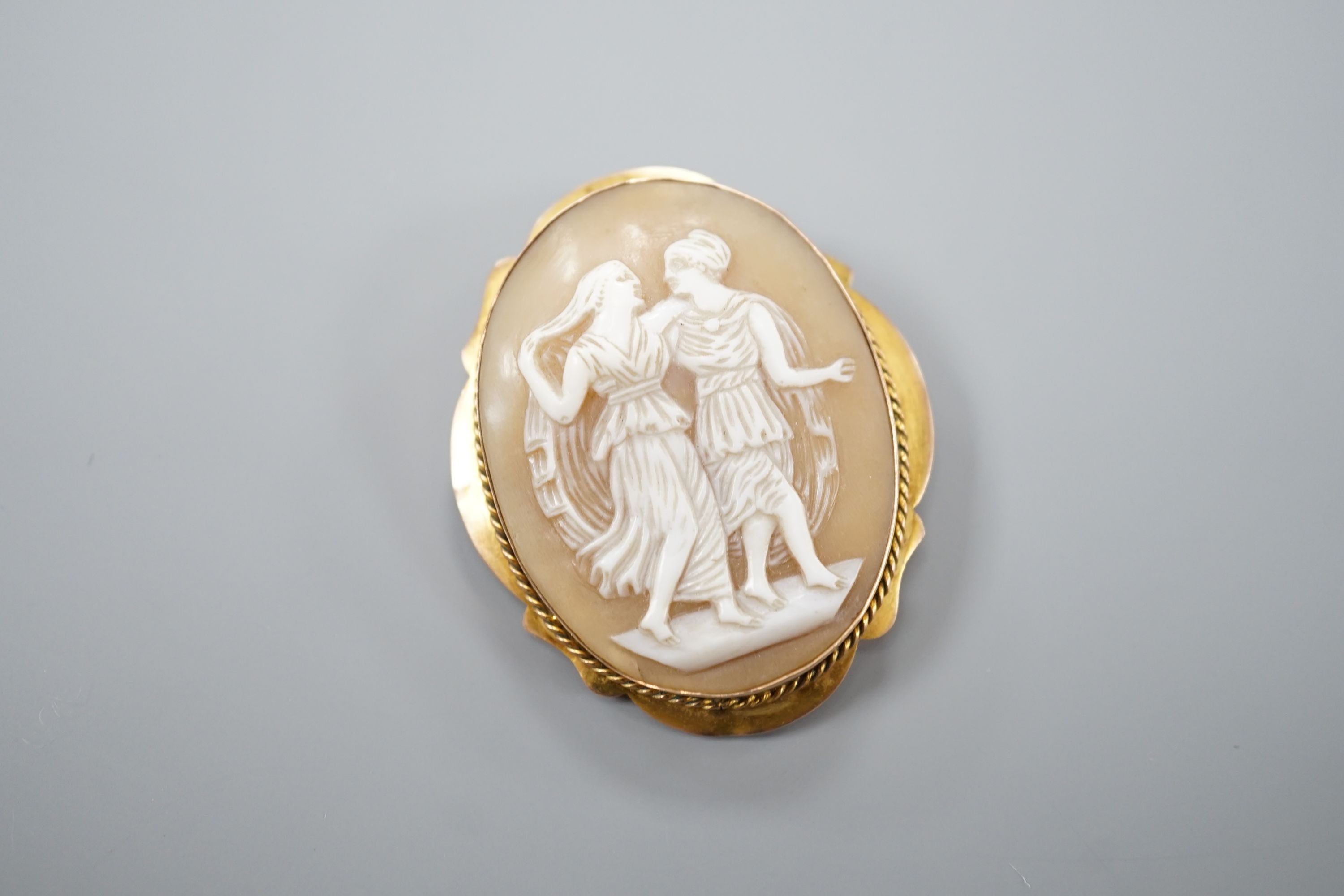 A 9ct mounted oval cameo shell brooch, decorated with two maidens, 46mm, gross 8.9 grams. - Image 2 of 3