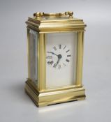 A small brass carriage time piece and key 9cm
