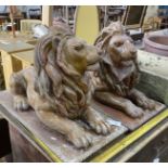 A pair of faux terracotta resin recumbent lion garden ornaments, length 74cm, width 36cm, height