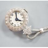 A lady's 1920's white metal (stamped platinum) and diamond chip set lapel watch, 6cm, gross weight