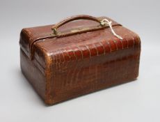 An early 20th century crocodile three tier travelling jewellery bag with key - 30cm long