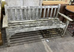 A weathered teak slatted garden bench, length 160cm, depth 54cm, height 82cm