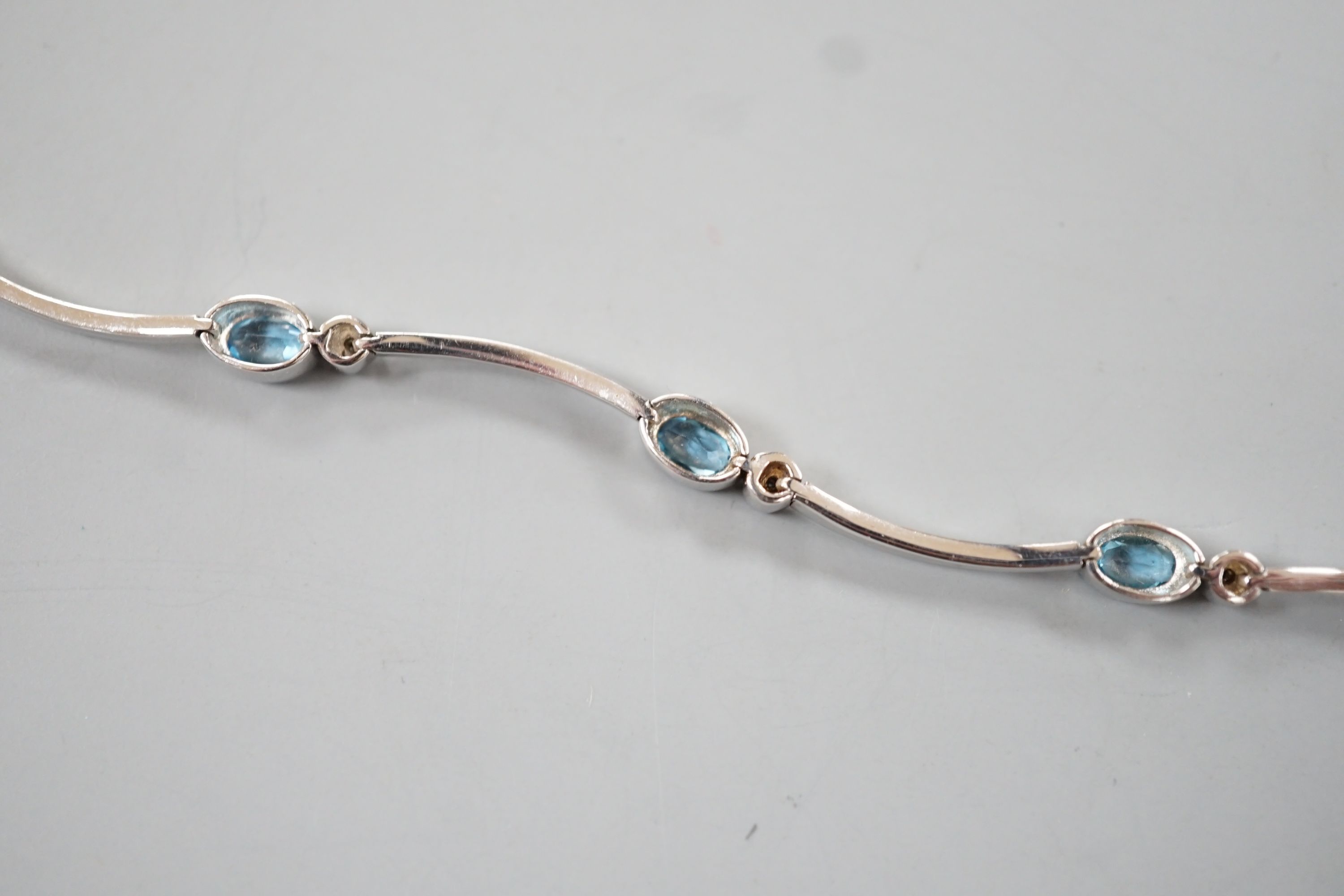 A modern 9ct white gold, blue topaz? and diamond chip set bracelet, 18.5cm, gross 8.8 grams. - Image 4 of 4