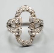 A white metal and diamond chip set open work oval dress ring, size M, gross 5.4 grams.