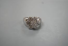 A modern 14k white metal and multiple diamond cluster set flower head ring, size M, gross weight 8.7