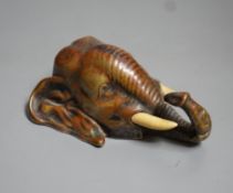 A bronze elephant head paperweight, early 20th century, with ivory inset tusks - 9cm high