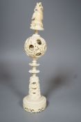 An early 20th century Chinese carved ivory concentric puzzle ball on stand 27cm