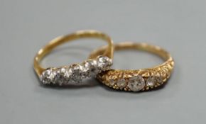 Two early 20th century 18ct and graduated five stone diamond set half hoop rings, gross 5.9 grams.