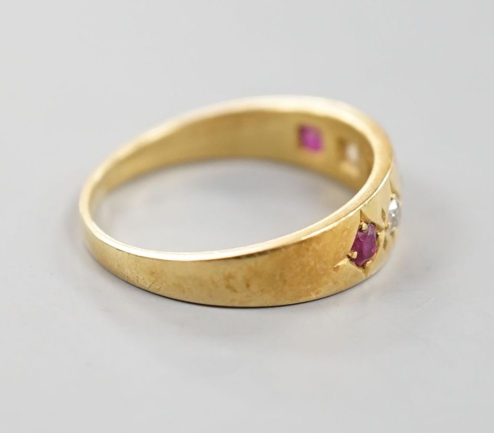 An early 20th century yellow metal and gypsy set three ruby and two stone diamond ring, size P, - Image 3 of 4