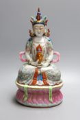 A Chinese famille rose seated Buddah, marked to base - 33cm tall