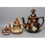 A Measham Bargeware pottery tea pot and cover and two similar reproductions