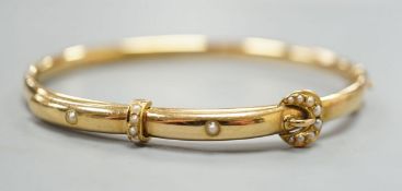 An Edwardian 15ct gold and seed pearl set hinged bracelet, interior diameter 58mm, gross weight 8.