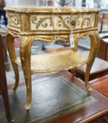 A Florentine gilt and cream painted serpentine two tier side table, width 50cm, depth 34cm, height