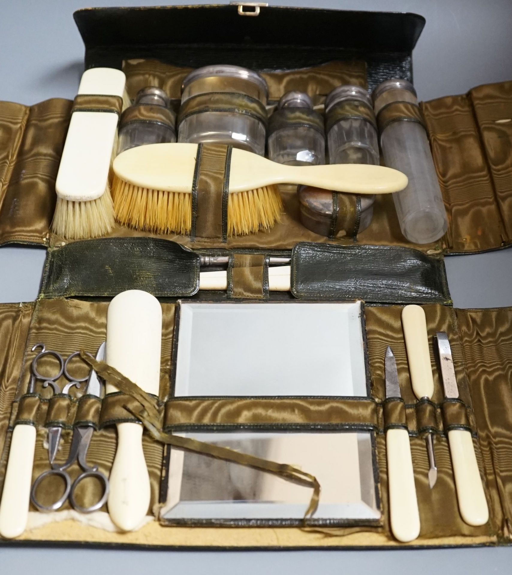 A George V J.C. Vickery leather travelling vanity case, containing five silver mounted toilet