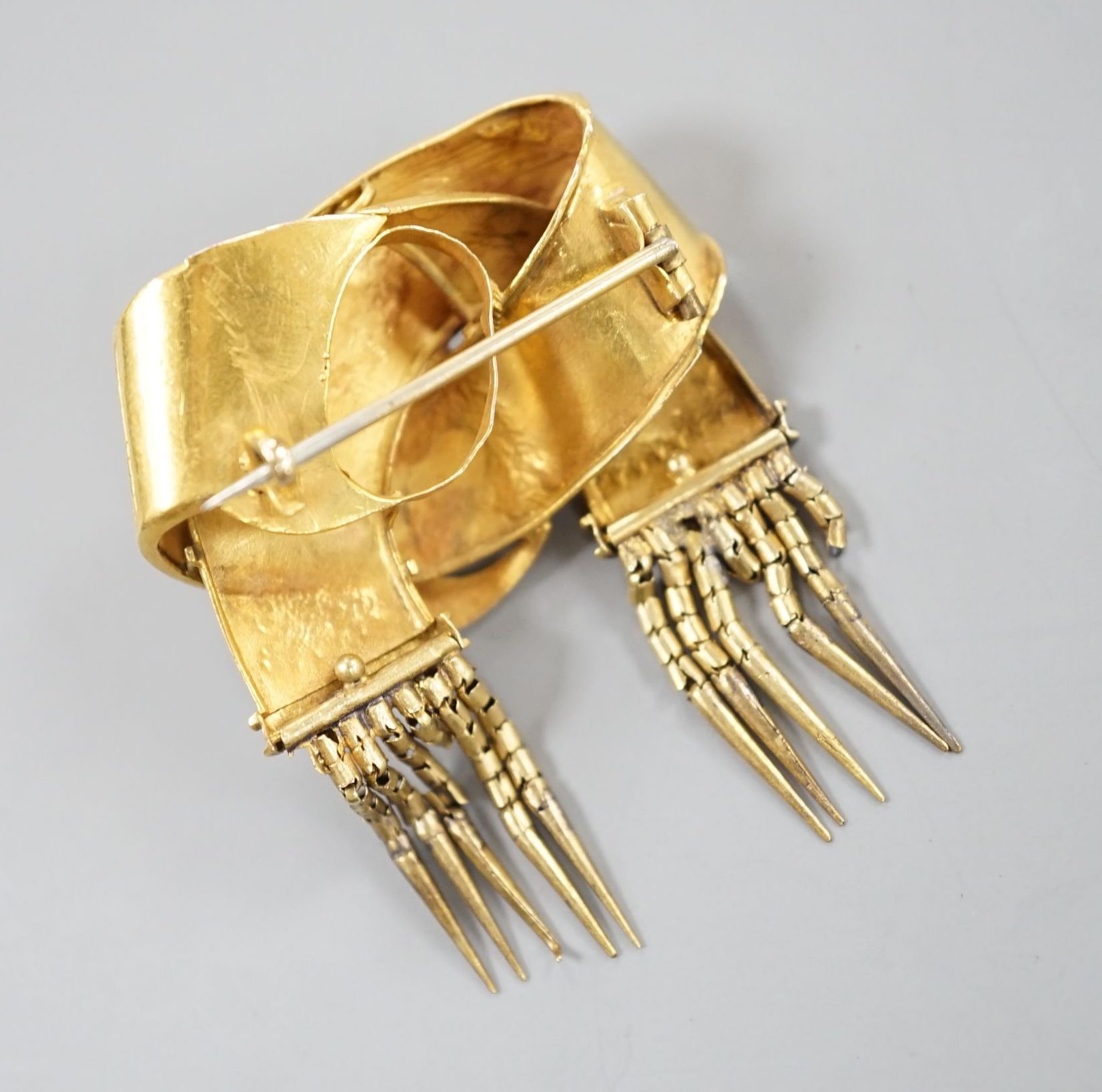 A late Victorian yellow metal entwined buckle and tassel brooch, width 30mm, 6.8 grams. - Image 2 of 2