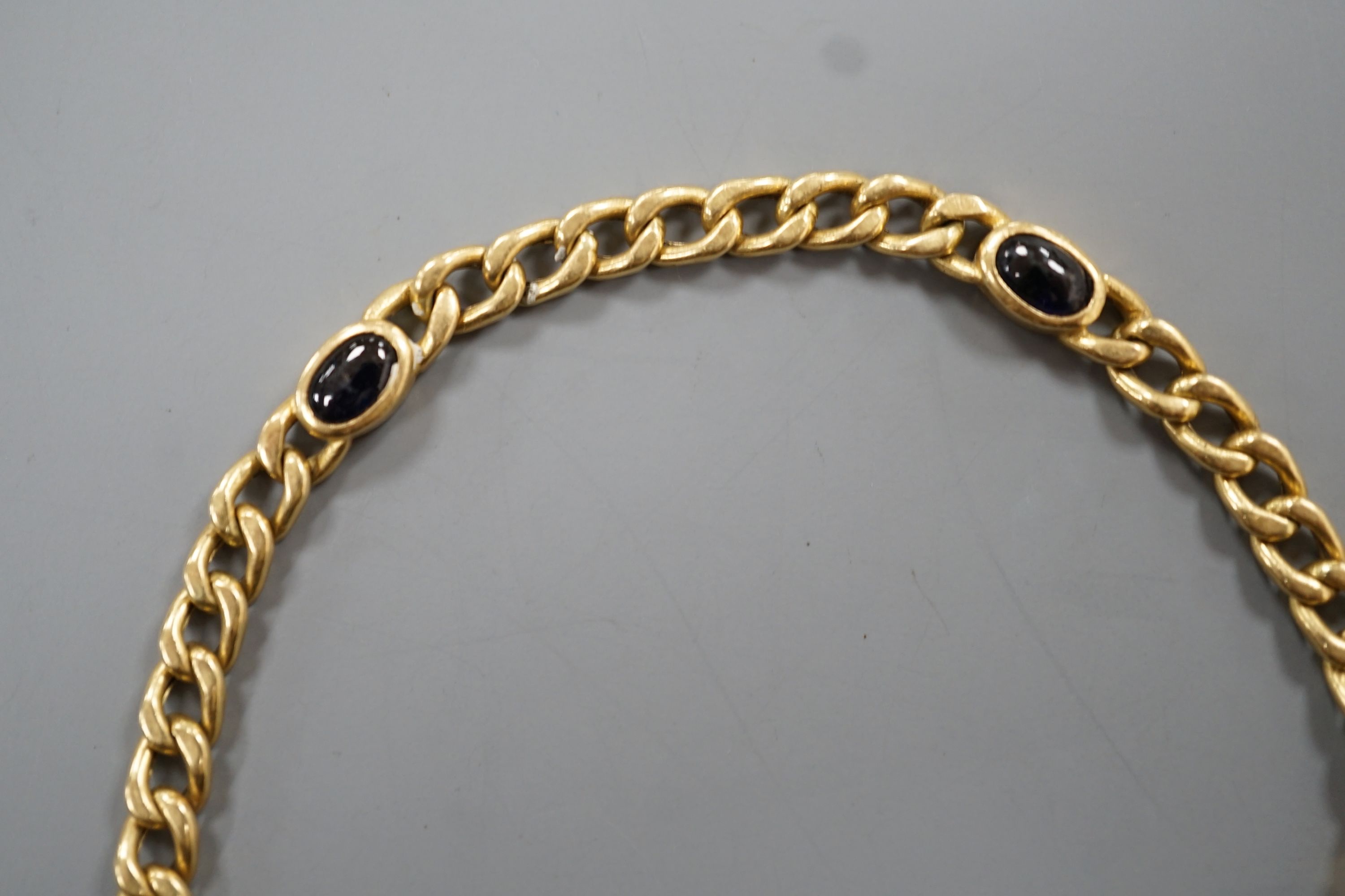 A yellow metal and blue cabochon stone set curb link bracelet, 18cm, gross weight 9 grams. - Image 4 of 4